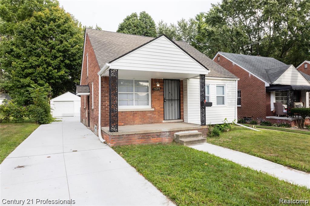 19372 Sunderland Road Detroit, MI 48219 - Photo 2 of 34 Traditional brick and siding residence featuring a covered front porch with decorative metal columns