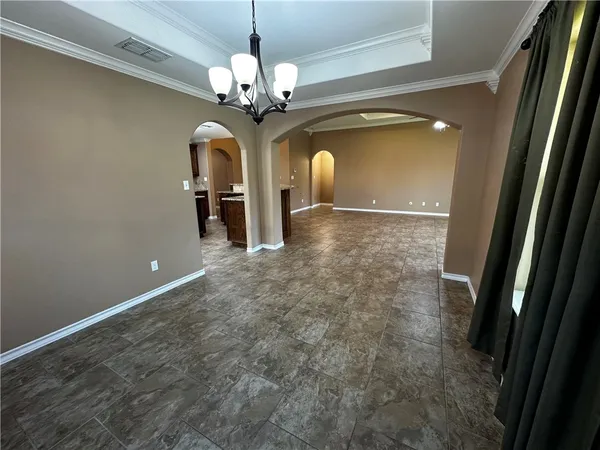 a bathroom with a granite countertop toilet sink and mirror