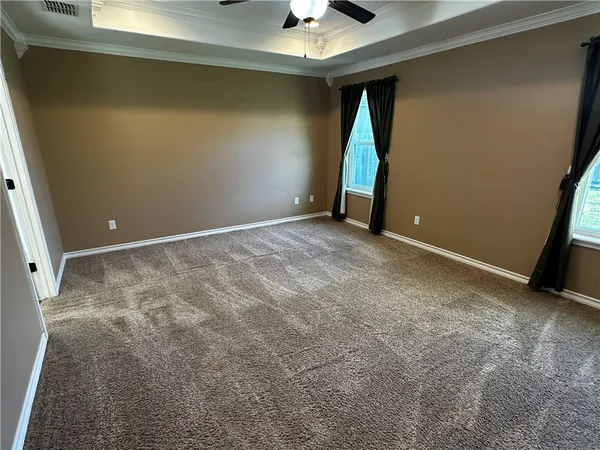 en empty room with fan and entrance