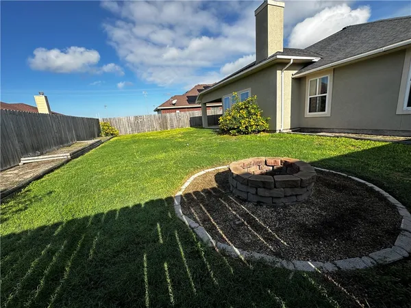 a view of a backyard of the house