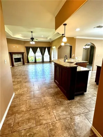 an empty room with windows and fireplace