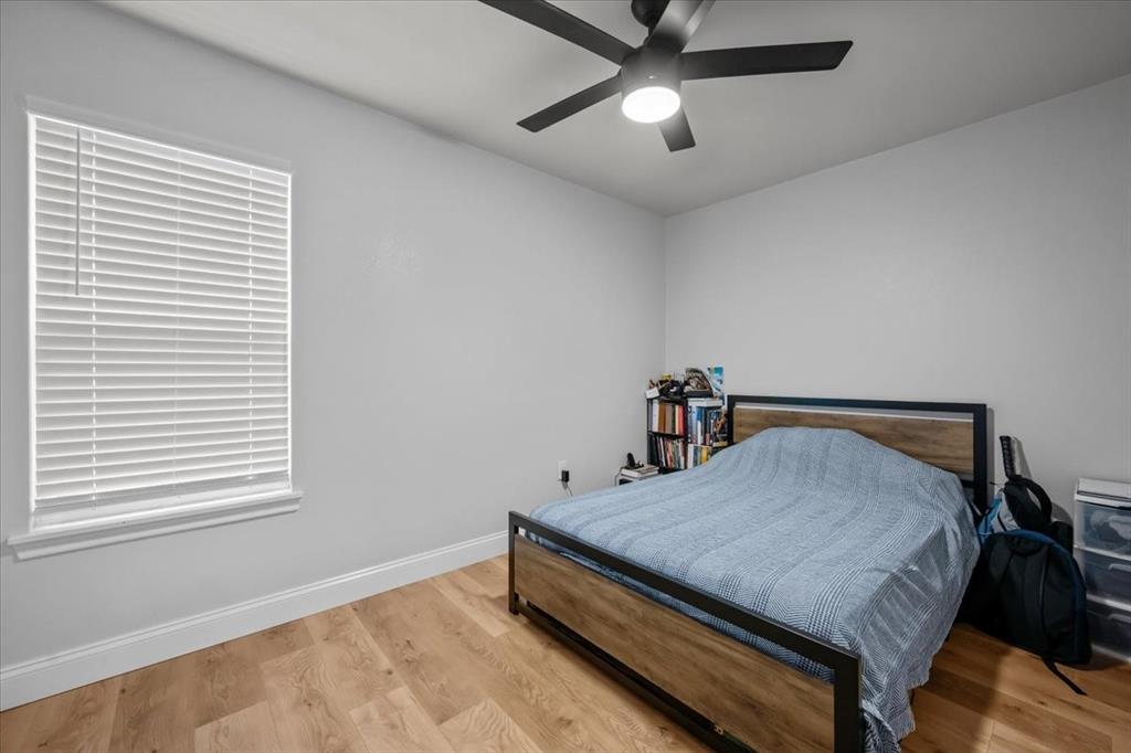 2804 Connor Avenue Waco, TX 76711 - Photo 11 of 21 a room with a bed and a chandelier fan