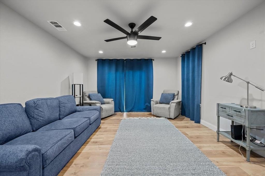 2804 Connor Avenue Waco, TX 76711 - Photo 15 of 21 a living room with furniture a fireplace and a ceiling fan
