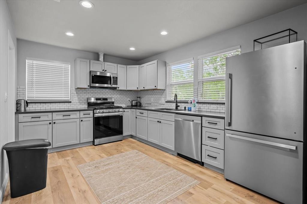 2804 Connor Avenue Waco, TX 76711 - Photo 5 of 21 a kitchen with granite countertop a refrigerator stove top oven and sink
