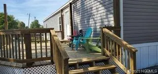 a view of deck with furniture and garden