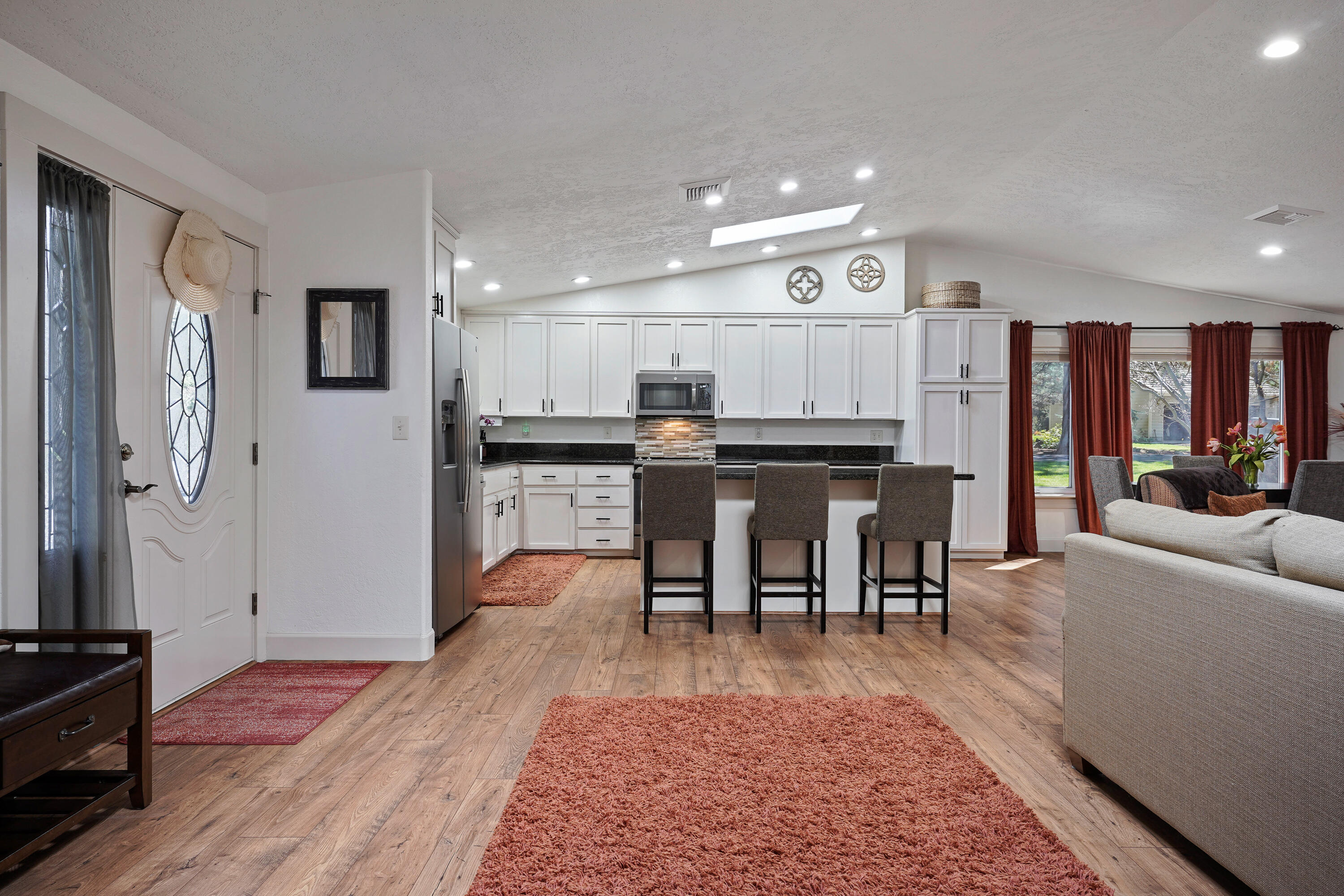 20452 Mainline Road Bend, OR 97702 - Photo 30 of 40 a living room with stainless steel appliances granite countertop furniture wooden floor and a rug