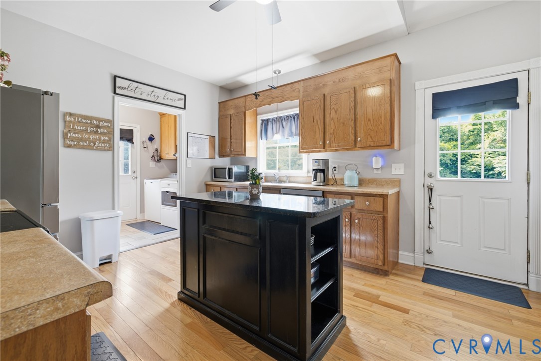 9433 Robin Road Disputanta, VA 23842 - Photo 11 of 26 Kitchen featuring wood-finish flooring, a central