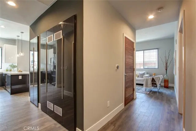 a view of a hallway with a living room couch and a view of living room