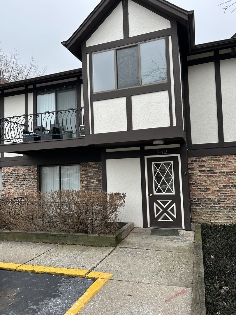 242 George Street, Unit B Bensenville, IL 60106 - Photo 1 of 11 a front view of a house with garage