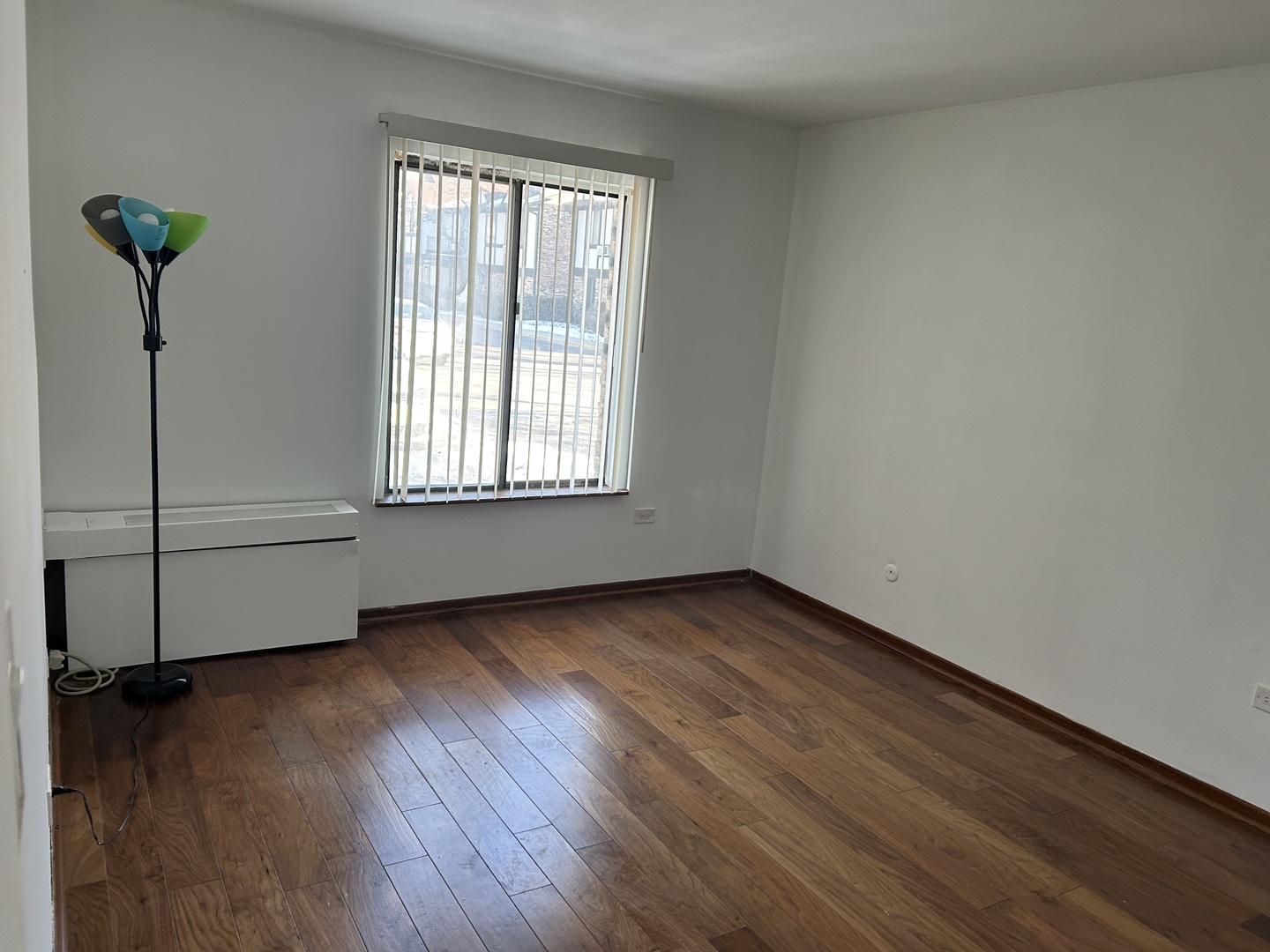 242 George Street, Unit B Bensenville, IL 60106 - Photo 3 of 11 a view of a livingroom with wooden floor and a window