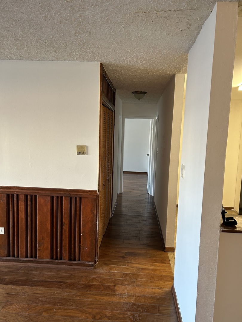 242 George Street, Unit B Bensenville, IL 60106 - Photo 9 of 11 a view of a hallway with wooden floor and a bathroom