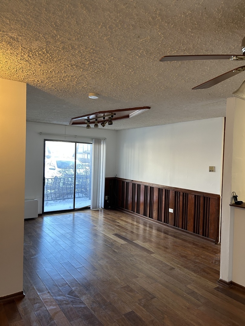 242 George Street, Unit B Bensenville, IL 60106 - Photo 10 of 11 a view of a room with wooden floor ceiling fan and windows