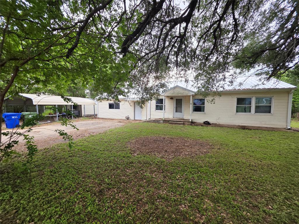 a view of house with yard