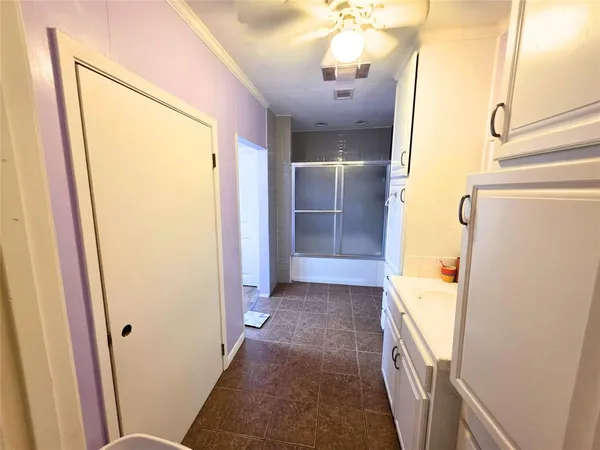a bathroom with a double vanity sink a mirror and shower