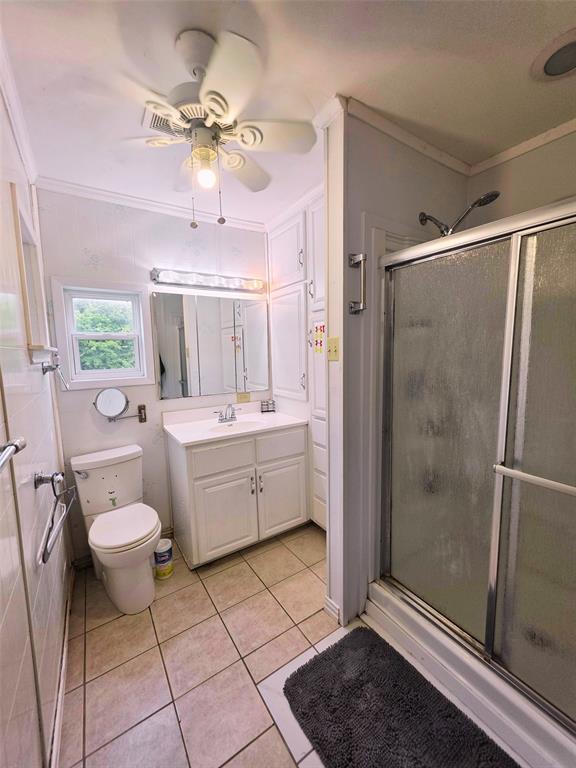 4214 Valview Drive Waco, TX 76708 - Photo 18 of 23 a bathroom with a sink toilet a mirror and shower