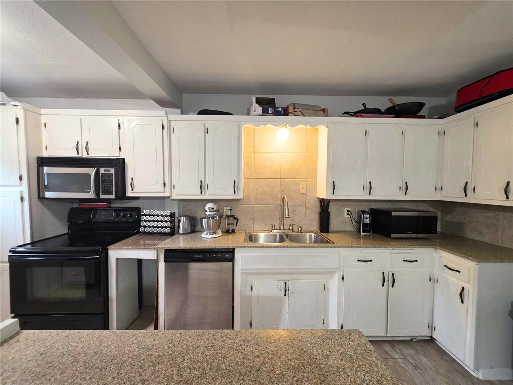 4214 Valview Drive Waco, TX 76708 - Photo 4 of 23 a kitchen with stainless steel appliances granite countertop a sink a stove a microwave a counter space and cabinets