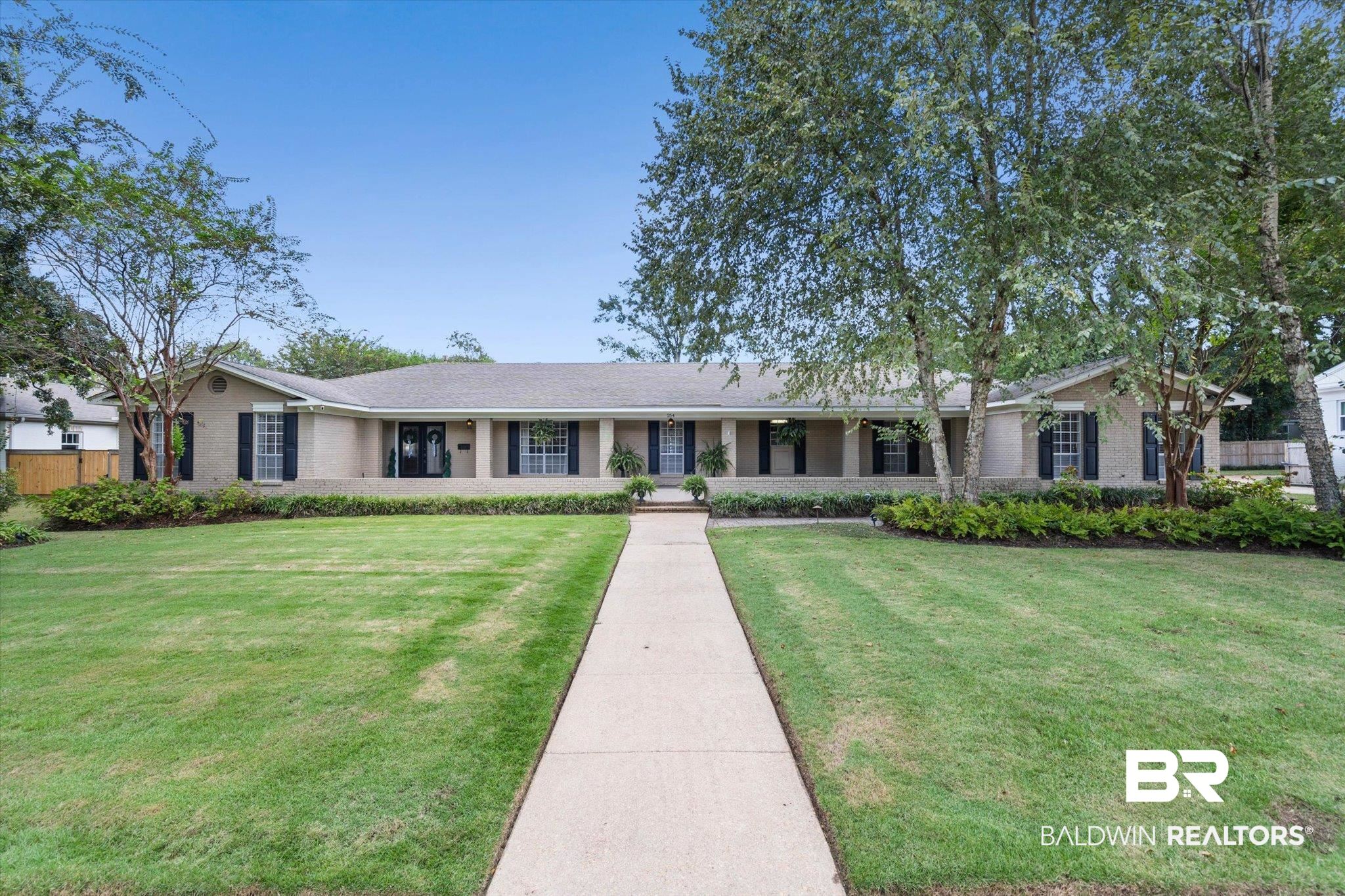 254 Woodlands Avenue Mobile, AL 36607 - Photo 41 of 50 Ranch-style house featuring a porch, a front lawn, and brick siding