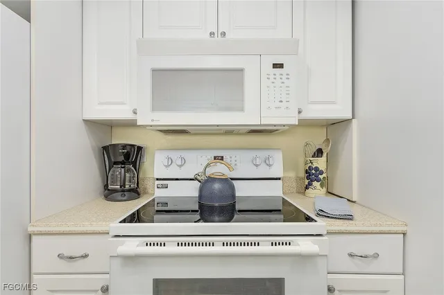 a kitchen with a stove and a cabinets