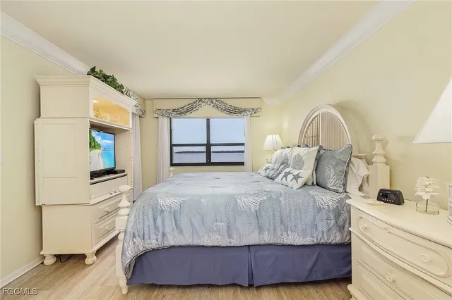 a bedroom with a large bed and a dresser