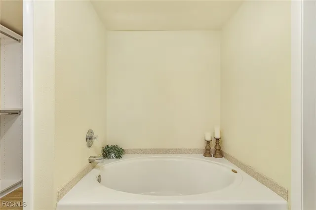 a white bath tub and shower