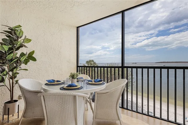 a dining room with furniture potted plants and wooden floor
