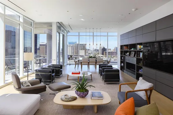 a dining room with furniture kitchen view and a large window