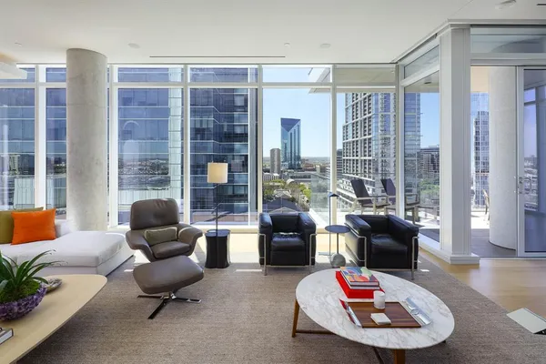 a living room with furniture and a floor to ceiling window