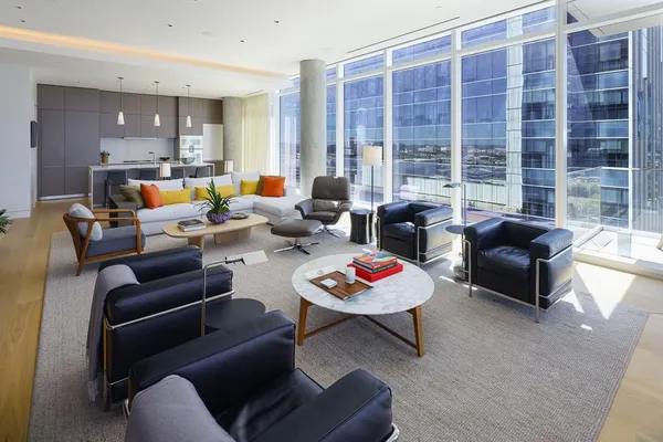 a living room with furniture and a floor to ceiling window