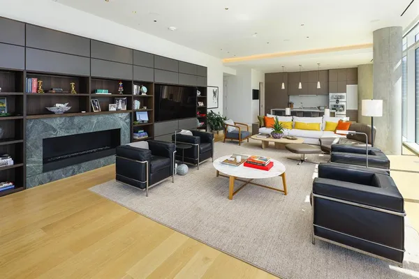 a living room filled with furniture and a flat screen tv