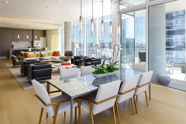 a living room with furniture a large window and a chandelier
