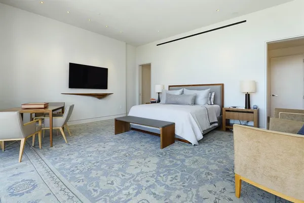 a bedroom with a bed and a chair