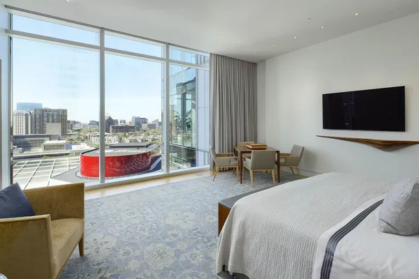 a bedroom with a bed and a flat screen tv