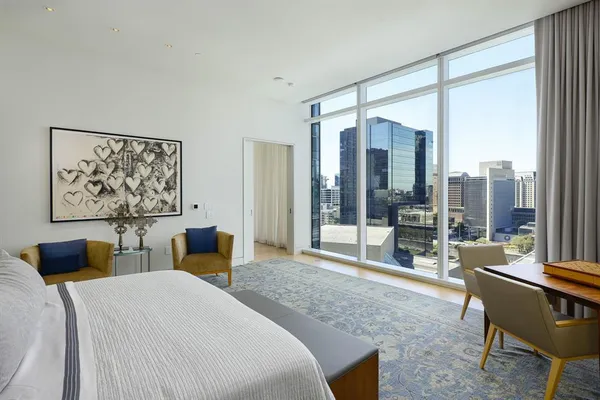 a bedroom with a large bed and a couch