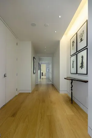 a big room with painting on the wall and a large window