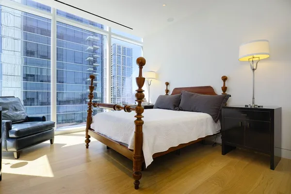 a bedroom with a bed and a lamp