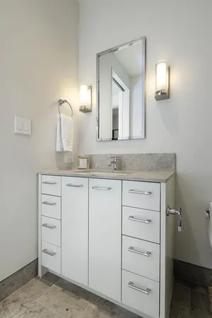 a bathroom with a granite countertop sink and a mirror