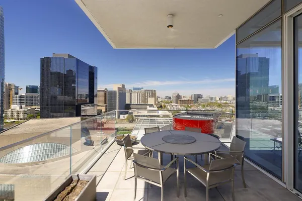 a view of a balcony dining table and chairs
