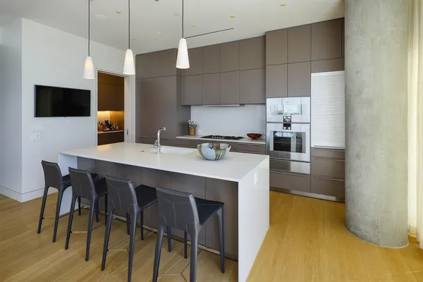 a kitchen with a table chairs refrigerator and microwave