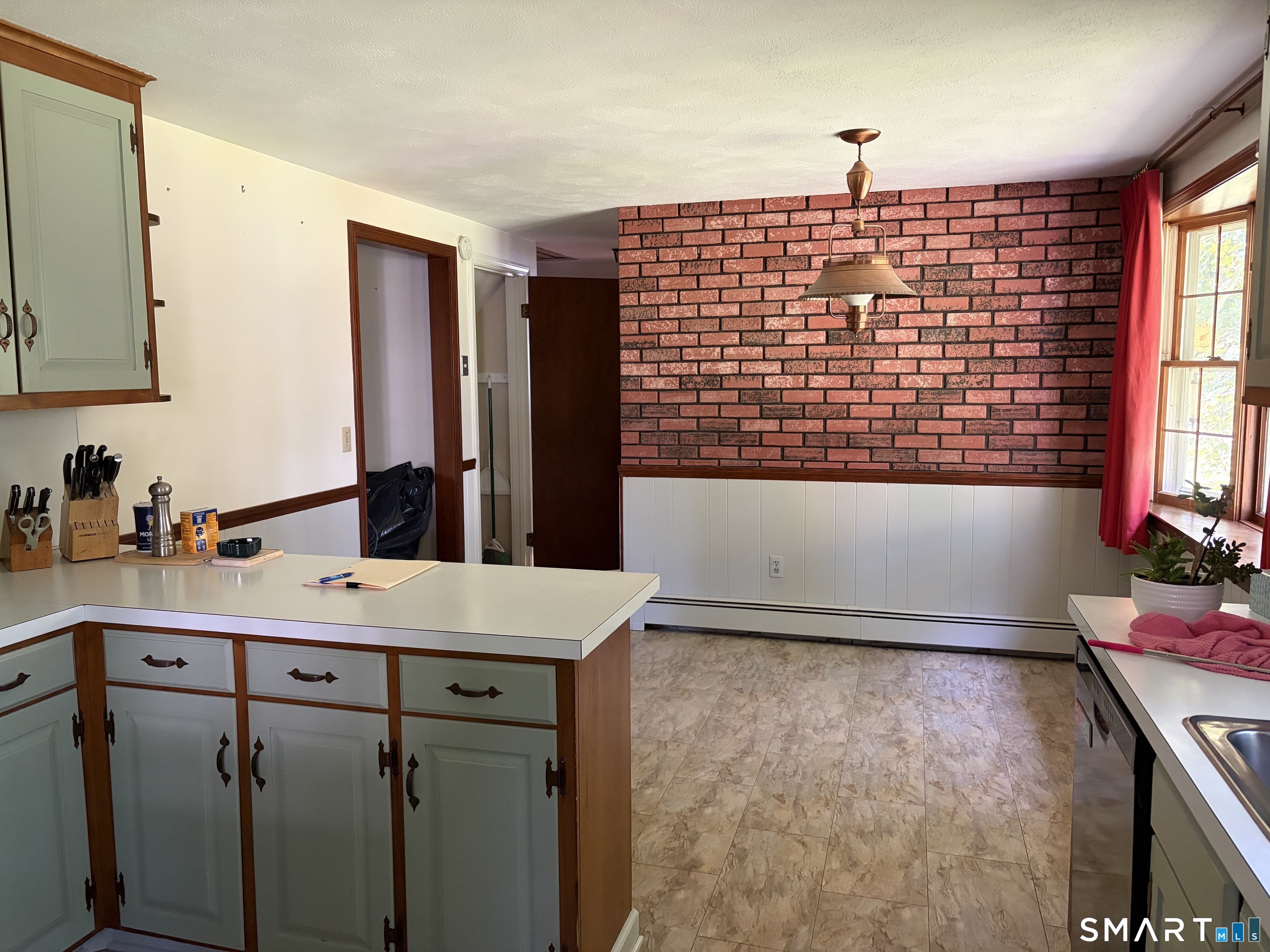 703 Laurel Grove Road Middletown, CT 06457 - Photo 5 of 18 There's a large space for your kitchen table in this delightful country kitchen.