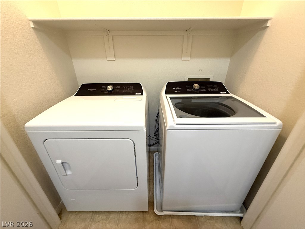 5942 Rampolla Drive Las Vegas, NV 89141 - Photo 25 of 27 Functional laundry nook provides convenient clothes care with modern appliances and overhead shelving.