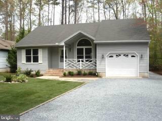 104 Sandyhook Road Ocean Pines, MD 21811 - Photo 1 of 6 a front view of a house with garden