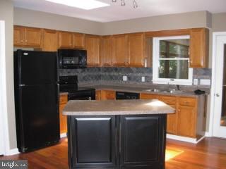 104 Sandyhook Road Ocean Pines, MD 21811 - Photo 3 of 6 a kitchen with stainless steel appliances granite countertop a sink a stove and a refrigerator