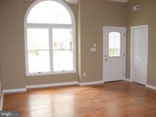 104 Sandyhook Road Ocean Pines, MD 21811 - Photo 4 of 6 an empty room with wooden floor and windows