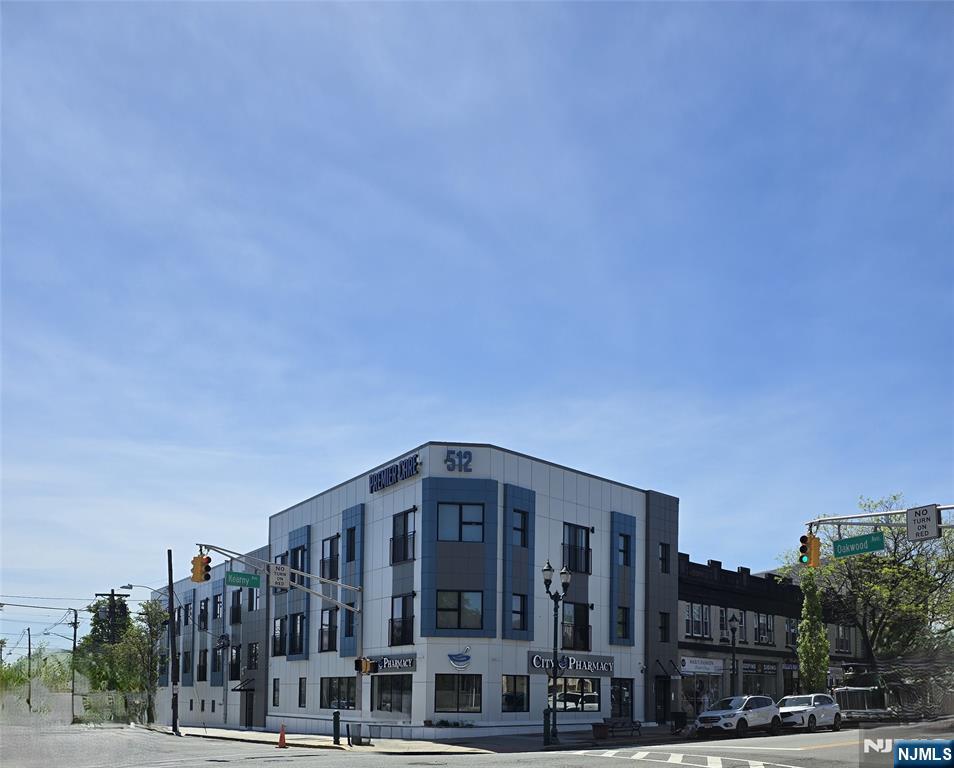 512 Kearny Avenue, Unit 302 Kearny, NJ 07032 - Photo 1 of 13 a front view of a building with streets and trees