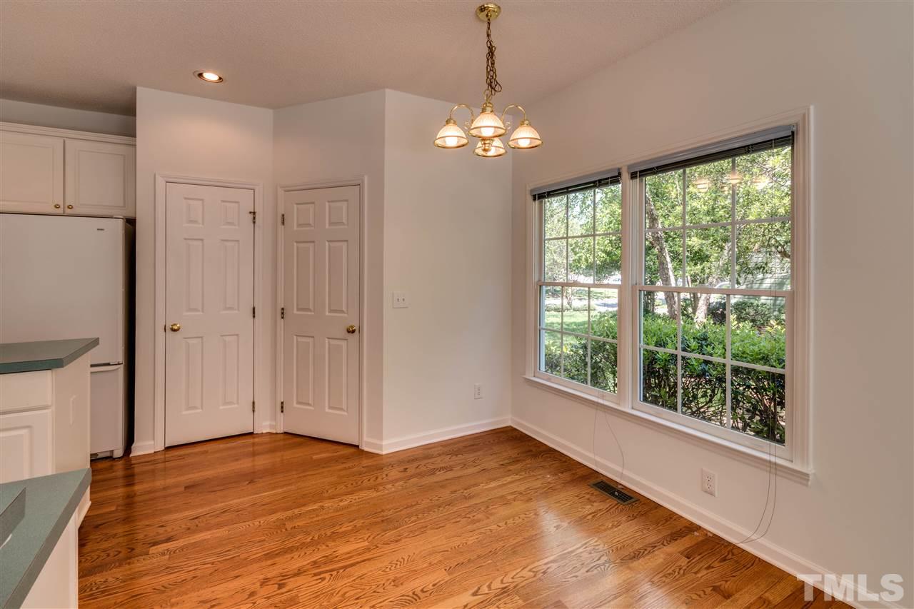 2337 Kendricks Court Raleigh, NC 27613 - Photo 13 of 25 a view of an empty room with wooden floor and a window