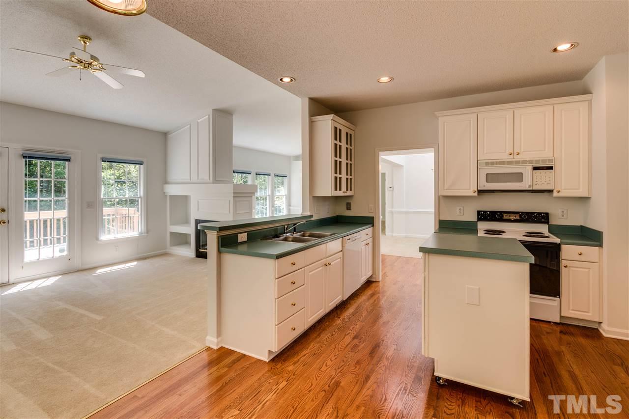 2337 Kendricks Court Raleigh, NC 27613 - Photo 14 of 25 a kitchen with stainless steel appliances a sink a stove a refrigerator cabinets and a window