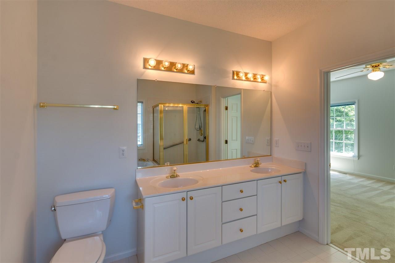 2337 Kendricks Court Raleigh, NC 27613 - Photo 17 of 25 a spacious bathroom with a granite countertop sink mirror and toilet
