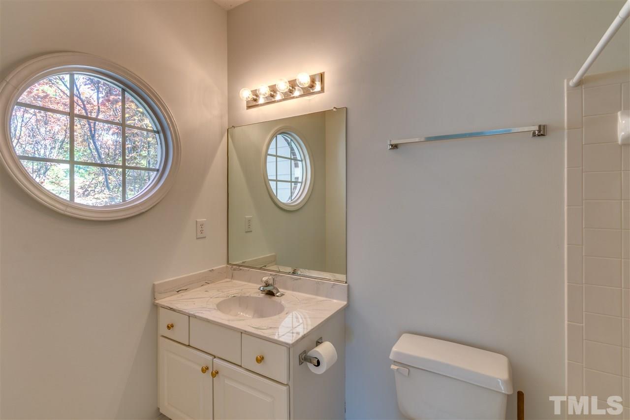 2337 Kendricks Court Raleigh, NC 27613 - Photo 20 of 25 a bathroom with a toilet a sink and a mirror