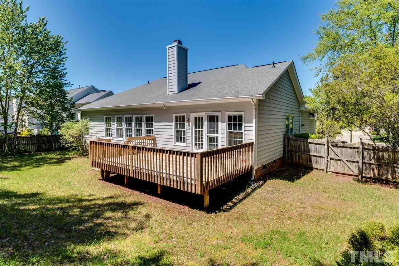 2337 Kendricks Court Raleigh, NC 27613 - Photo 25 of 25 a view of a house with a wooden deck and a yard with trees