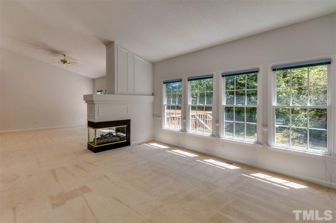 2337 Kendricks Court Raleigh, NC 27613 - Photo 5 of 25 a view of an empty room with a fireplace and a window